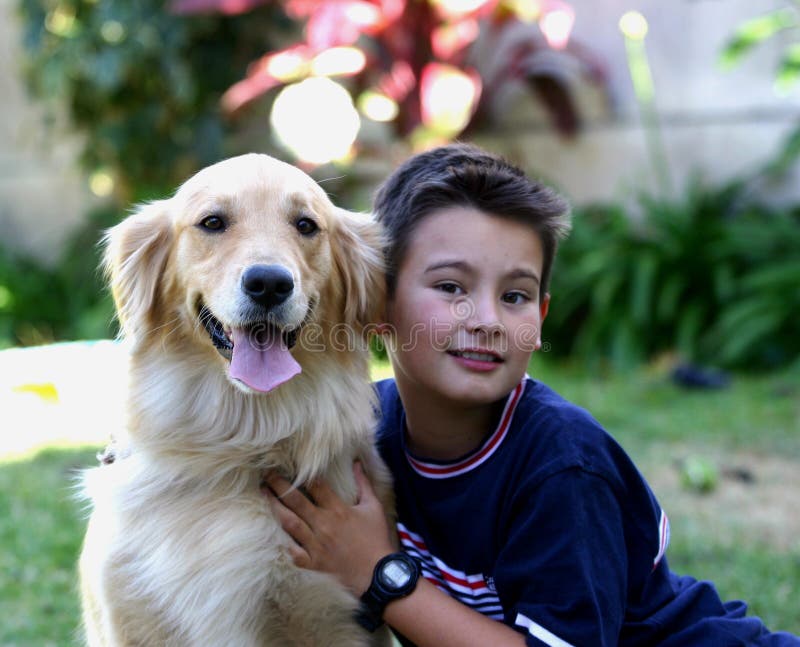 A kid with his Golden Retriever dog. A kid with his Golden Retriever dog