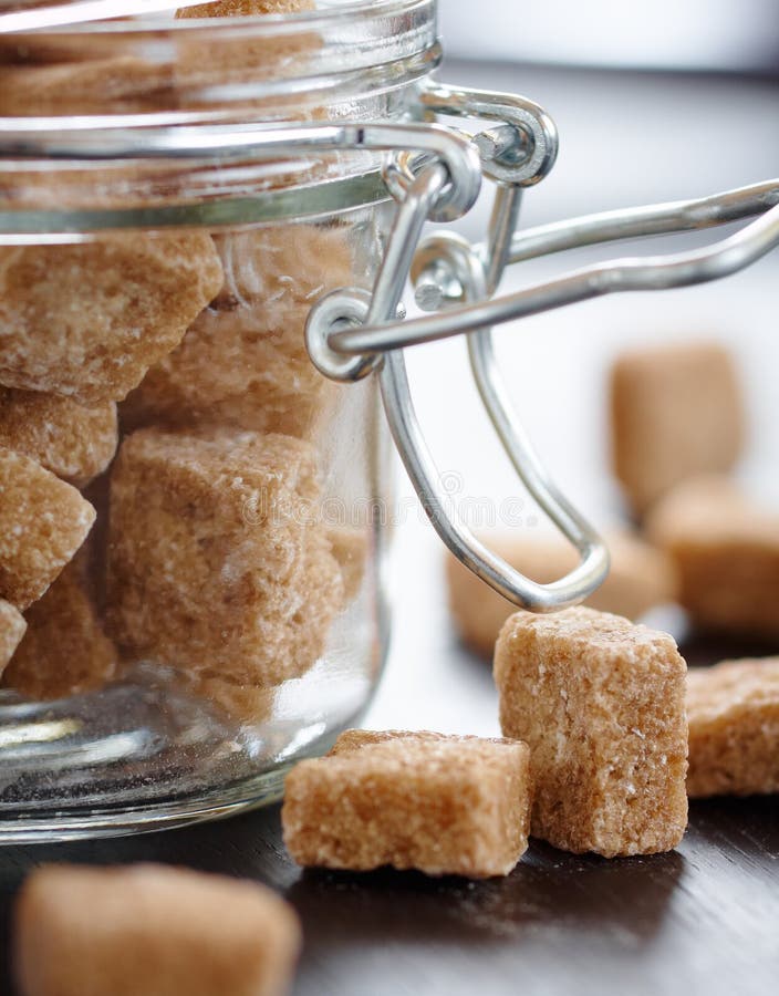 Cubes of brown sugar in the glass jar,closeup. Cubes of brown sugar in the glass jar,closeup