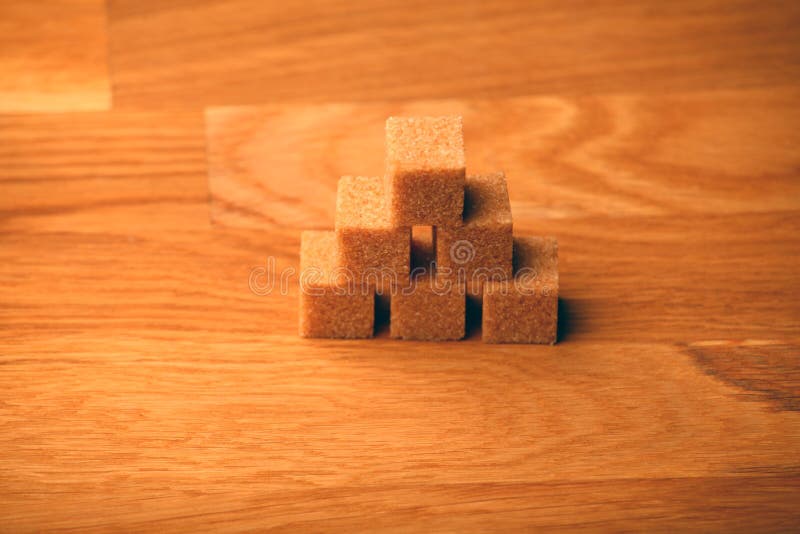 Cane sugar blocks wooden table stock photography Cane sugar blocks wooden table stock photography