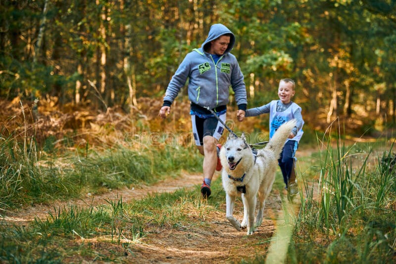 Canicross Cross Country Running with Dog, Father and Son Running with