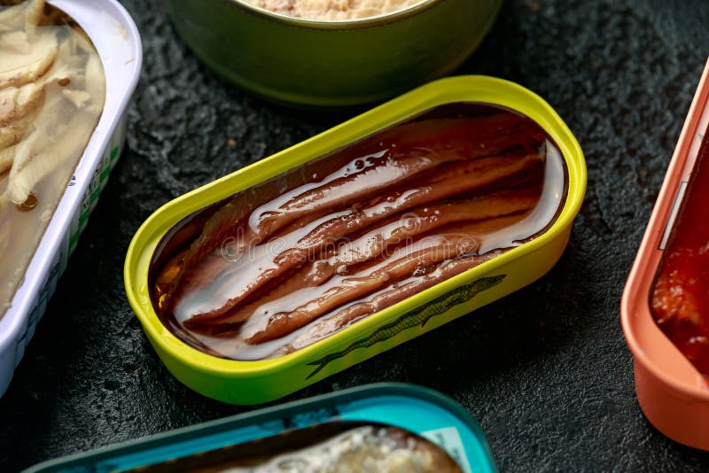 Canned Fish with Different Assortment Types of Seafood on Rustic Stone