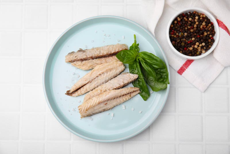 Canned Mackerel Fillets Served on White Tiled Table, Flat Lay Stock