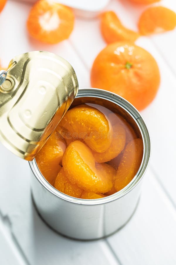 Canned Tangerine. Pickled Mandarin Fruit in Can on White Table Stock