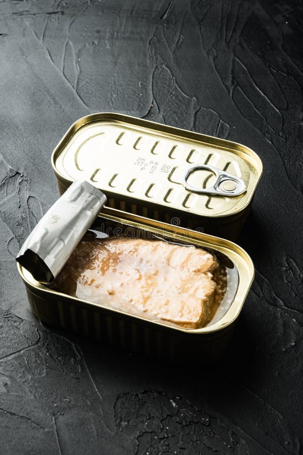 Canned Wild Alaska Salmon, in Tin Can, on Black Background Stock Image