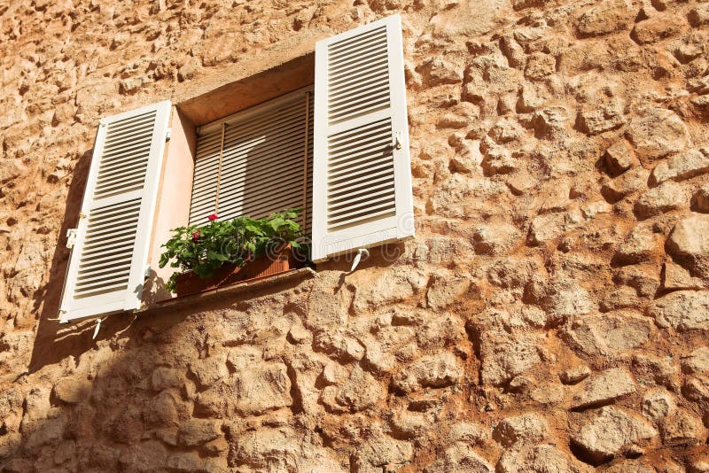 Flowers in a window sill in Cannes, France. Flowers in a window sill in Cannes, France