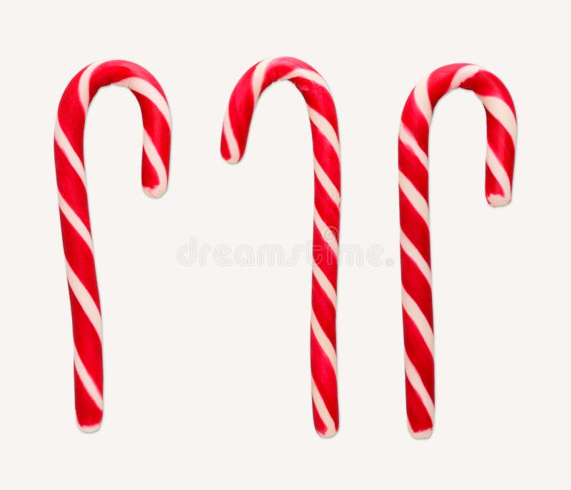 Cannes de sucrerie de Noël rouge et blanc d'isolement sur le blanc photographie stock Cannes de sucrerie de Noël rouge et blanc d'isolement sur le blanc photographie stock