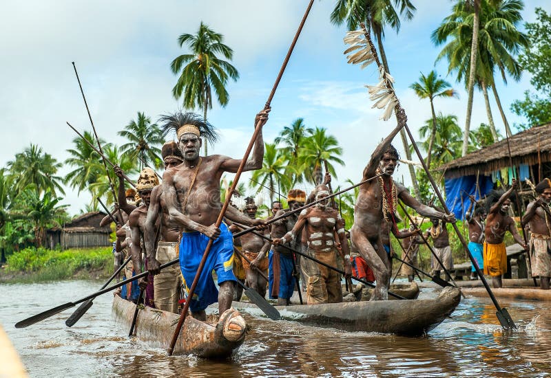 Canoe War Ceremony Of Asmat People. Headhunters Of A Tribe 