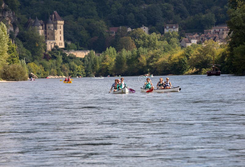 La Roque-Gageac, Dordogne, France - September 7, 2018: Canoeing on Dordogne river in La Roque-Gageac, Aquitaine, France. La Roque-Gageac, Dordogne, France - September 7, 2018: Canoeing on Dordogne river in La Roque-Gageac, Aquitaine, France