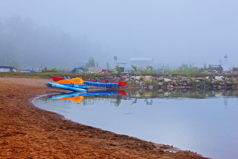 Canoes and kayak in fog stock image Canoes and kayak in fog stock image