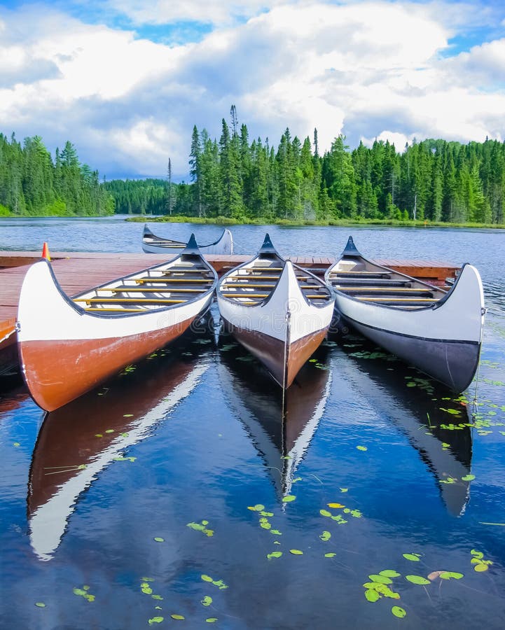 Canoes Reflected on a Canadian Lake Stock Image Image of canoeing