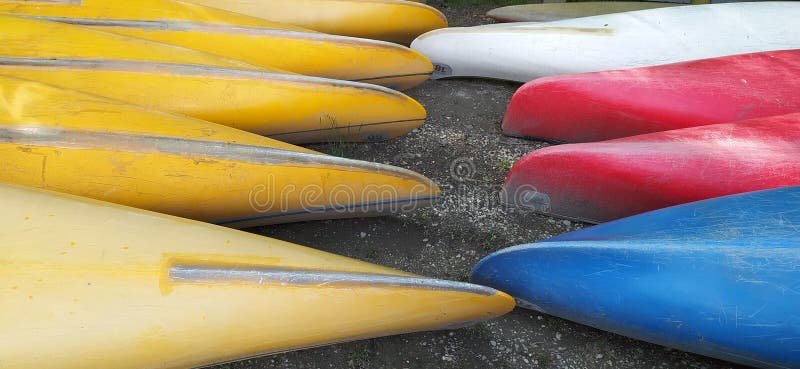 Canoes on the shore waiting for children in the summer camp