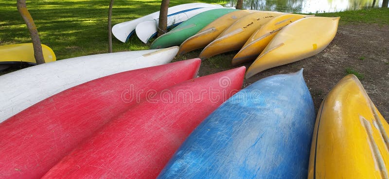 Canoes on the shore waiting for children in the summer camp