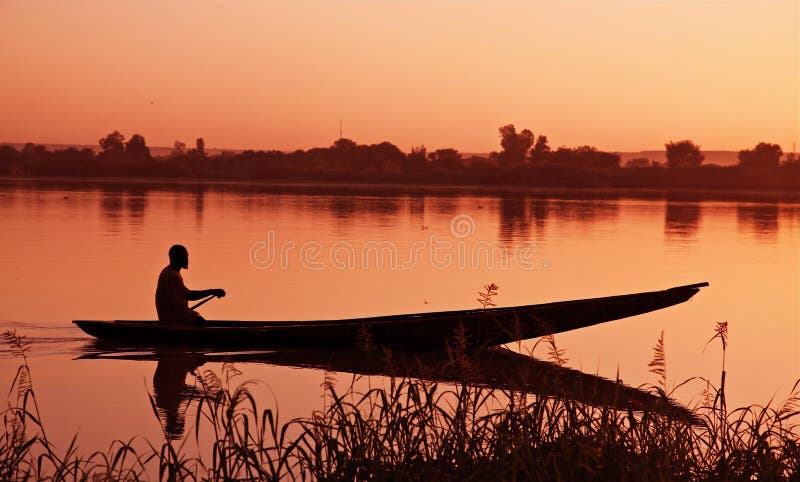 Fisherman in his boat at sunset. Fisherman in his boat at sunset