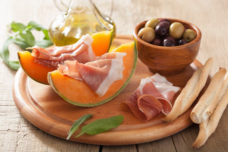 Cantaloupe Melon with Prosciutto and Olives. Italian Appetizer Stock