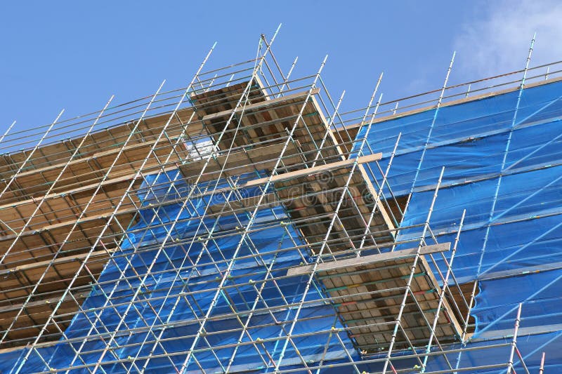 Modern apartment construction site with scaffolding an tarpaulin covering. Modern apartment construction site with scaffolding an tarpaulin covering