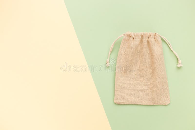 Canvas bag with drawstring, mockup of small eco sack made from natural cotton fabric cloth flat lay on green pastel background royalty free stock images Canvas bag with drawstring, mockup of small eco sack made from natural cotton fabric cloth flat lay on green pastel background royalty free stock images
