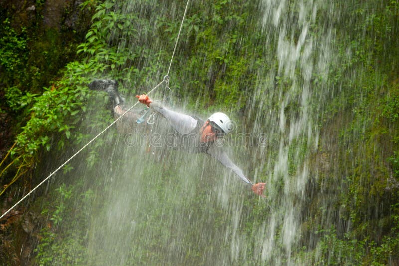 Canyoning Tour Leader Jumping Into A Waterfall