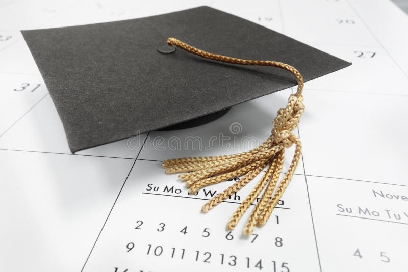 Graduate study abroad concept : Graduation cap on calendar paper