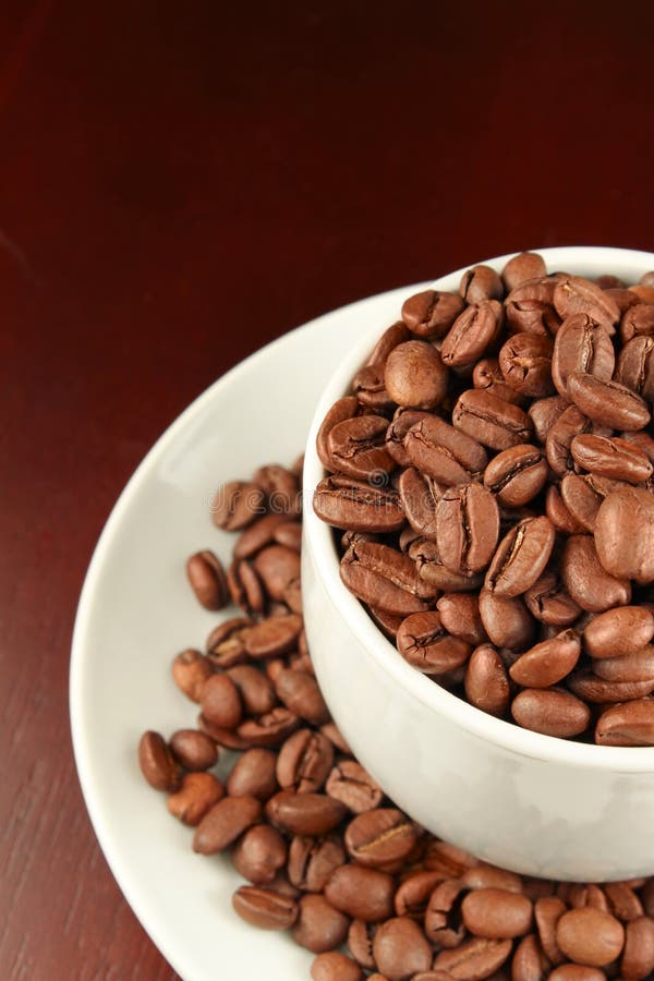 Cup of Coffee Filled Up with Coffee Beans Stock Image Image of table