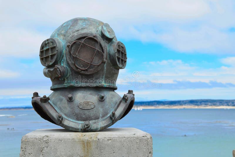 An old deep sea diving helmet commemorates the cannery divers who maintained the floating hoppers and underwater pipes that pumped sardines to canneries in Monterey California in the 1940s. An old deep sea diving helmet commemorates the cannery divers who maintained the floating hoppers and underwater pipes that pumped sardines to canneries in Monterey California in the 1940s.