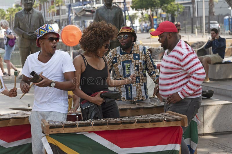 Cape Town, South Africa. December 2019. Street musician in revealing black top plays xylophone on the waterfront area of central Cape Town. Cape Town, South Africa. December 2019. Street musician in revealing black top plays xylophone on the waterfront area of central Cape Town