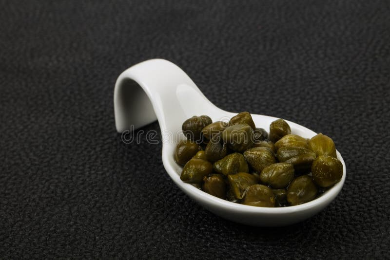 Capers in the bowl stock photography