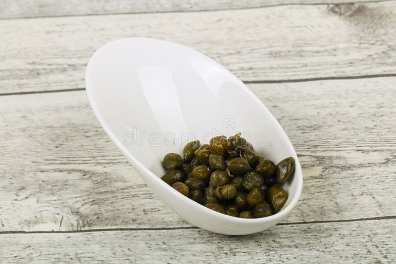Capers in the bowl stock photography