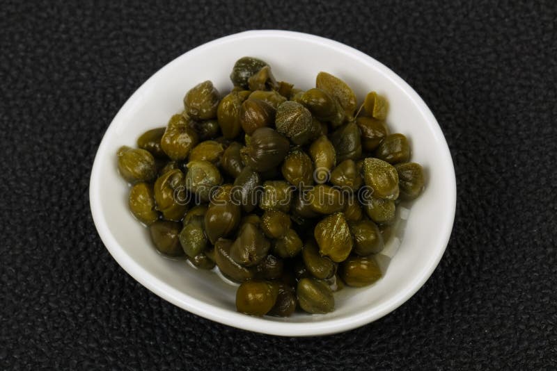 Capers in the bowl stock image