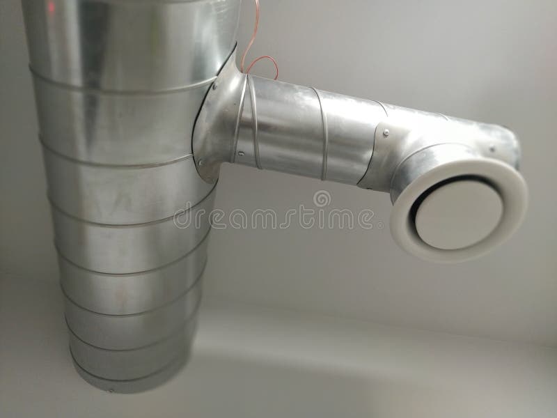 Campana extractora en un baño público. Tubo metálico redondo con