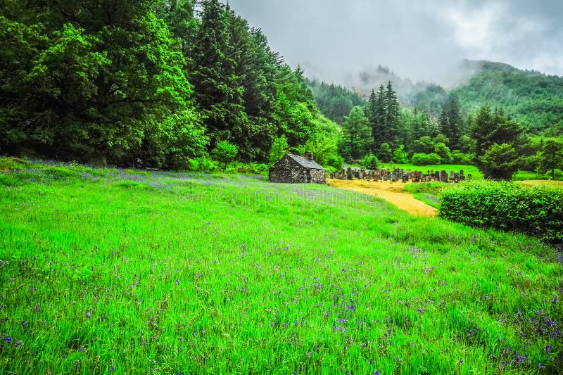 An old stone chapel and a small cemetery sits in a misty forest just outside of Glencoe, Scotland. An old stone chapel and a small cemetery sits in a misty forest just outside of Glencoe, Scotland