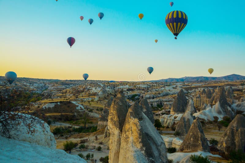 Cappadocia, Goreme, Anatolia, Turkey: Colorful hot air balloons flying over rock landscape, Cappadocia is known around the world stock image Cappadocia, Goreme, Anatolia, Turkey: Colorful hot air balloons flying over rock landscape, Cappadocia is known around the world stock image