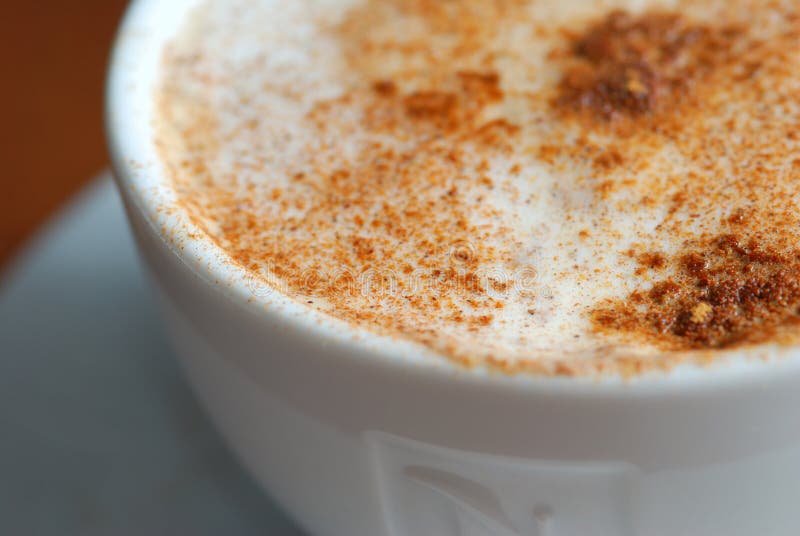 Cup of cappuccino with cinnamon close up