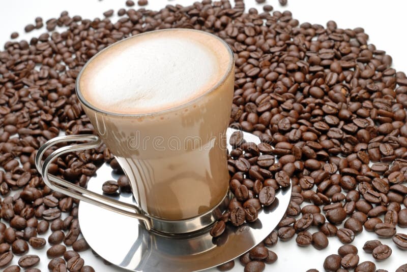 Cappuccino and roasted coffee beans
