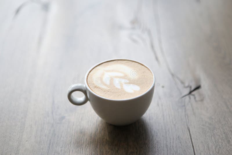 Cappuccino in white glass with wire drawing on milk froth royalty free stock photos Cappuccino in white glass with wire drawing on milk froth royalty free stock photos