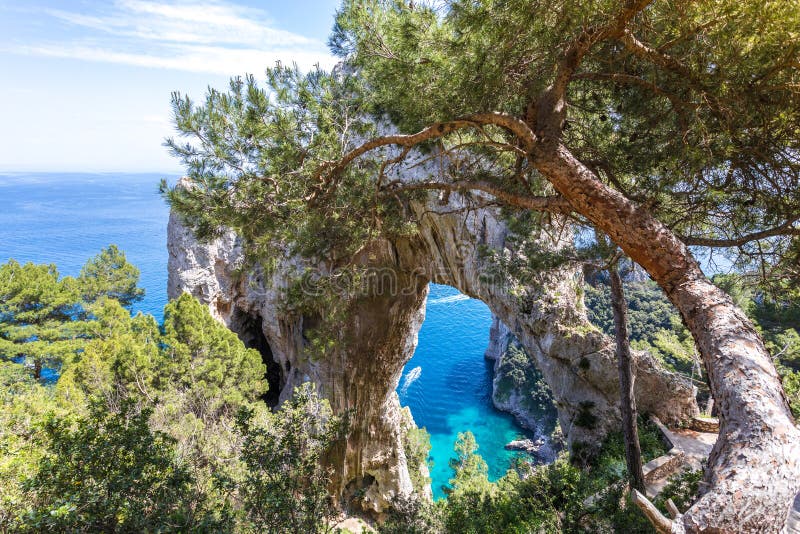 Capri Italien, ön i en härlig sommardag, med faraglioni vaggar och den naturliga stenbågen royaltyfria bilder Capri Italien, ön i en härlig sommardag, med faraglioni vaggar och den naturliga stenbågen royaltyfria bilder