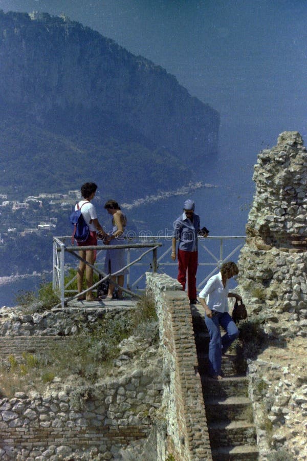 CAPRI, ITALY, 1971 - Tourists visit the ruins of Villa Jovis on Monte Tiberio while admiring the view.