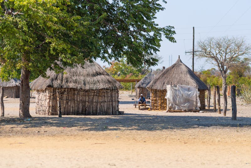 Caprivi, Namibia - August 20, 2016: Poor people busy in their village in the rural Caprivi Strip, the most populated region in Namibia, Africa. Caprivi, Namibia - August 20, 2016: Poor people busy in their village in the rural Caprivi Strip, the most populated region in Namibia, Africa.