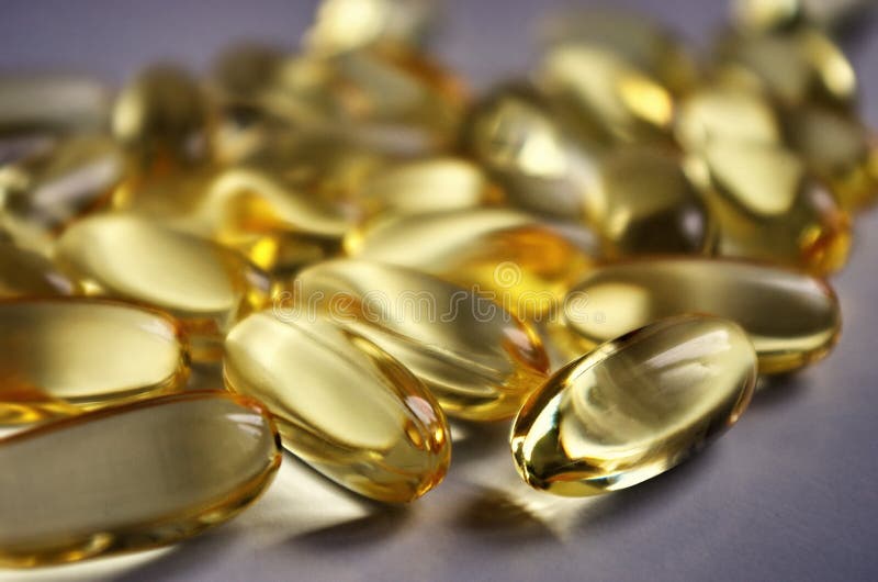 Fish oil capsules with omega 3 and vitamins A & D. Healthy lifestyle. Pharmacy industry.Healthy lifestyle. Background suplement concept. Fish oil capsules with omega 3 and vitamins A & D. Healthy lifestyle. Pharmacy industry.Healthy lifestyle. Background suplement concept