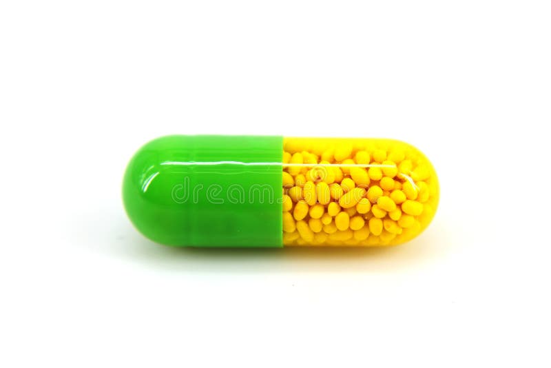 Green and yellow medicine capsule on white background. Green herbal drug medicine stock images, royalty-free photos and pictures