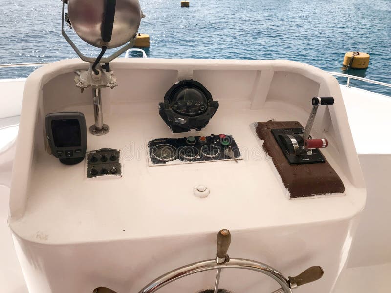 The captain`s cabin on the ship, boat, cruise liner with the steering wheel, dashboard, navigator, speedometer and control device