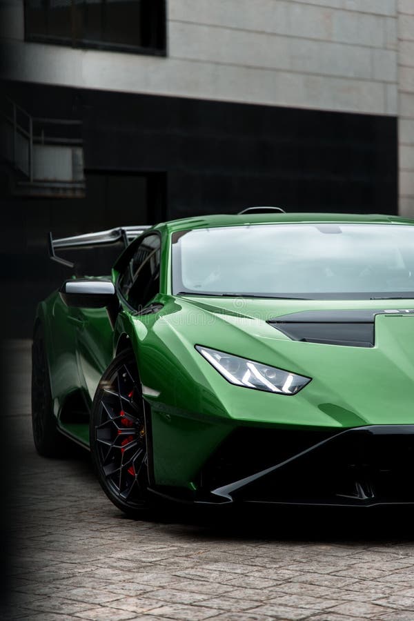 A vertical shot of a beautiful sleek luxurious Lamborghini Huracan Sto parked outdoors. A vertical shot of a beautiful sleek luxurious Lamborghini Huracan Sto parked outdoors