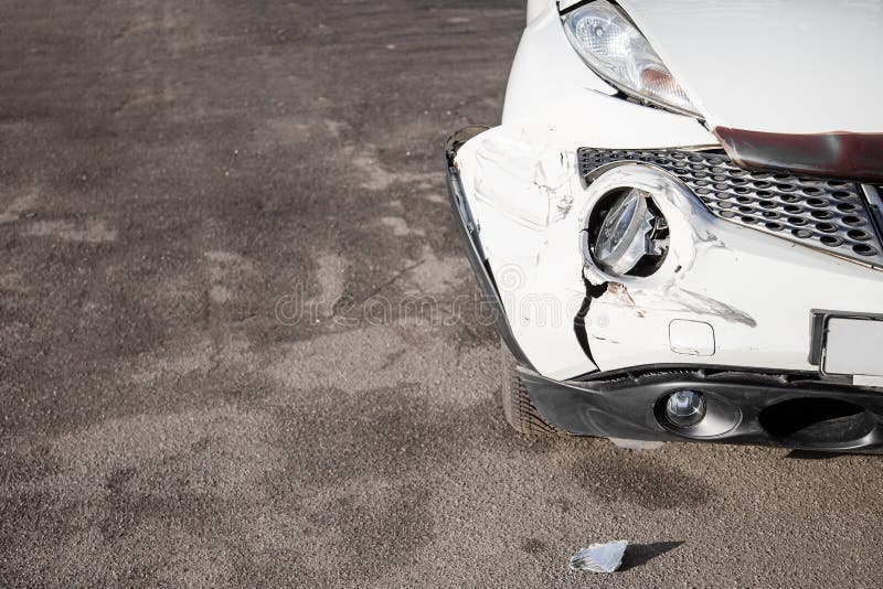 Broken Car after a Crash. Damaged Wing and Headlamp of a Car