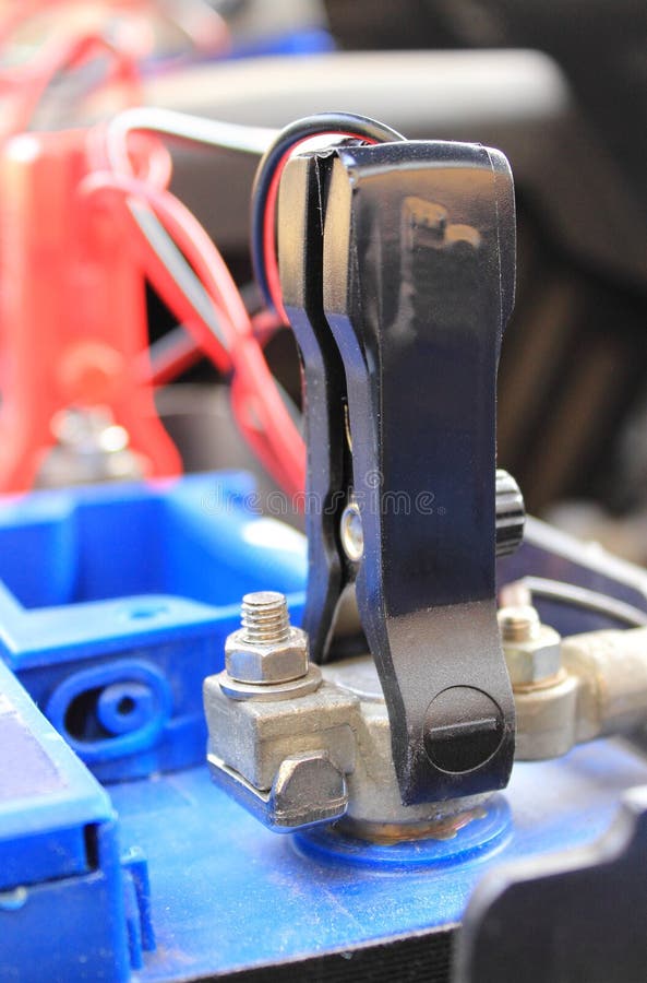 Car Battery with Clamps and Connected Cables of Charger Stock Photo