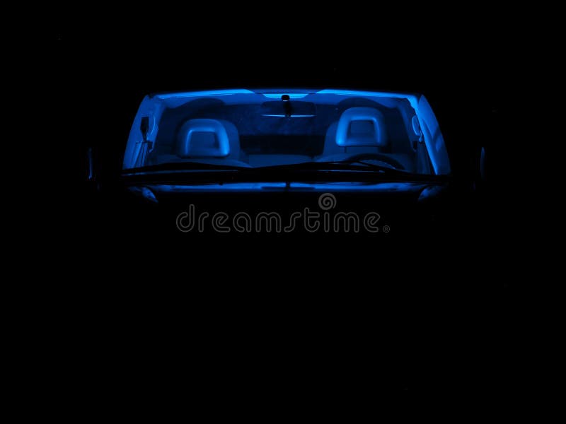 A Car with Blue Neon Light Inside the Passenger Compartment, on a Dark
