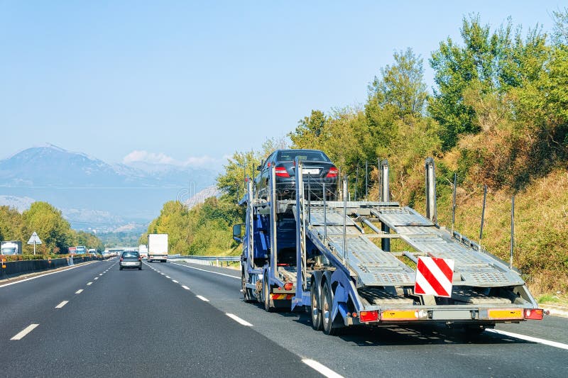 Car carrier truck on road stock photo. Image of driving 128070422