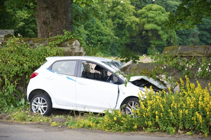 Car crash in rural countryside and damaged wall