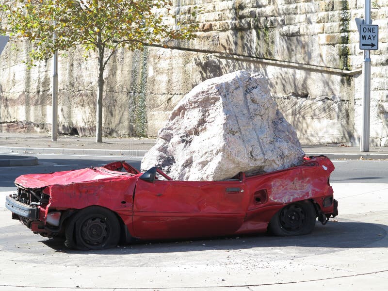 Car crushed by rock stock photos Car crushed by rock stock photos