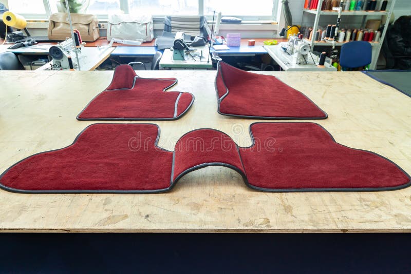 Car 3D handmade floor mats of red color from wool for front and rear passengers of a vehicle in an interior design workshop with royalty free stock photography Car 3D handmade floor mats of red color from wool for front and rear passengers of a vehicle in an interior design workshop with royalty free stock photography