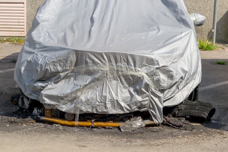 Car damaged by fire. Partially burnt cars covered with a gray film on a city street. royalty free stock image Car damaged by fire. Partially burnt cars covered with a gray film on a city street. royalty free stock image
