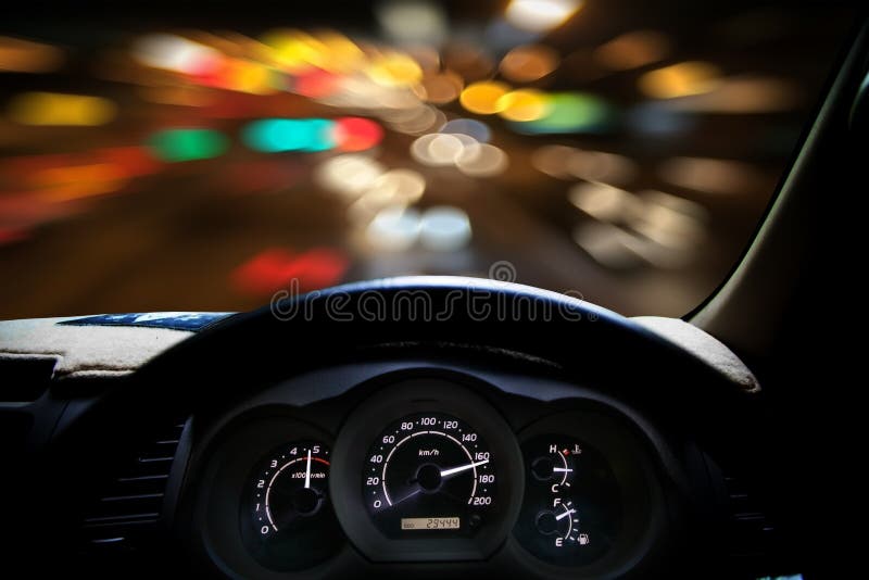 Car Dashboard Speeds while on the Road. Car Driving Fast. Stock Photo